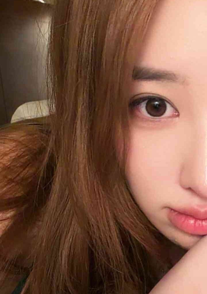 KL Escort Girl Close-up of a young woman with long brown hair and brown eyes, looking at the camera. Escort Malay